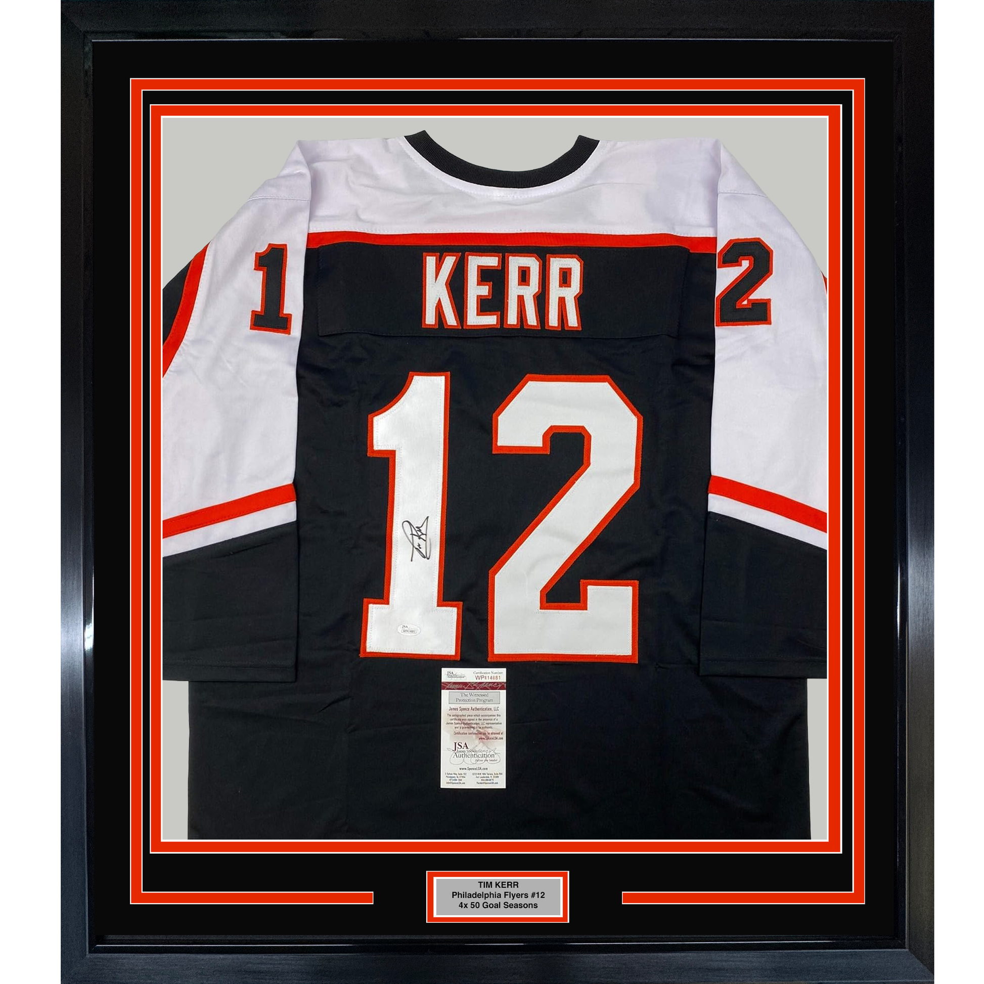 Framed black Philadelphia Flyers #12 hockey jersey signed by Tim Kerr, displayed front-facing with red and white trim and JSA authentication certificate.