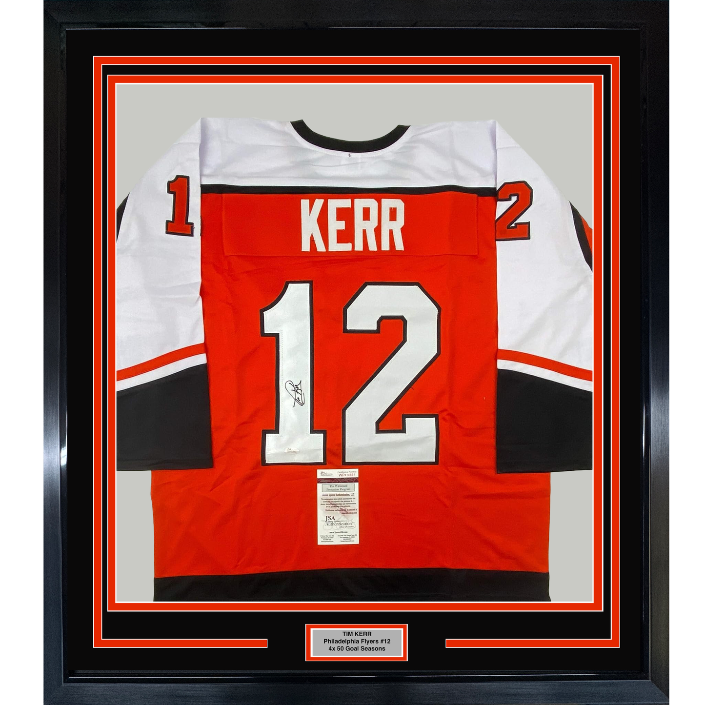 Framed red Philadelphia Flyers #12 jersey signed by Tim Kerr, displayed front-facing with white and black trim and JSA authentication certificate visible.
