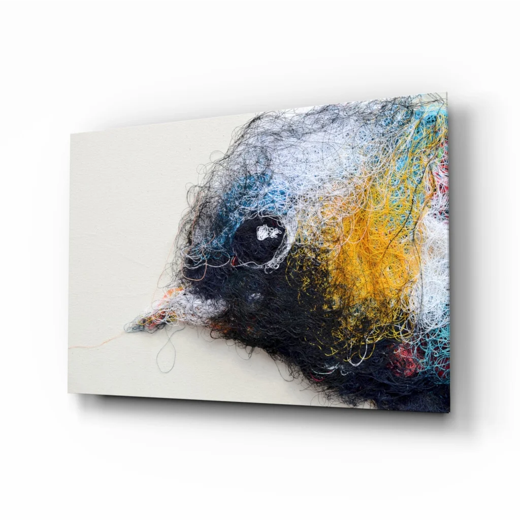 Abstract bird head in black, yellow, blue, white threads on glass wall art
