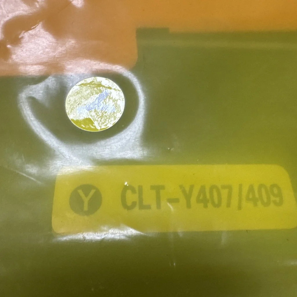 Toner cartridge CLT-Y407/409 circular metallic component with reflective blue yellow patterns