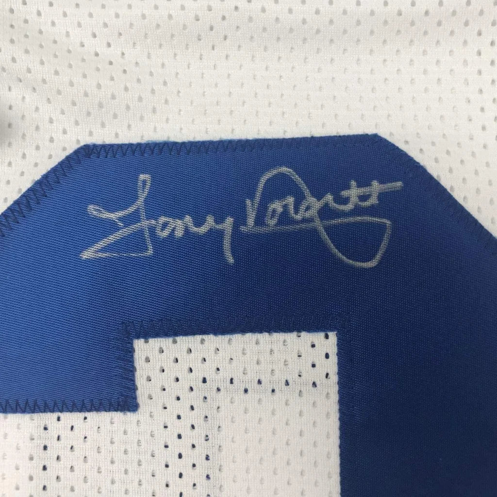 White Dallas Cowboys jersey with blue number and silver autograph for display