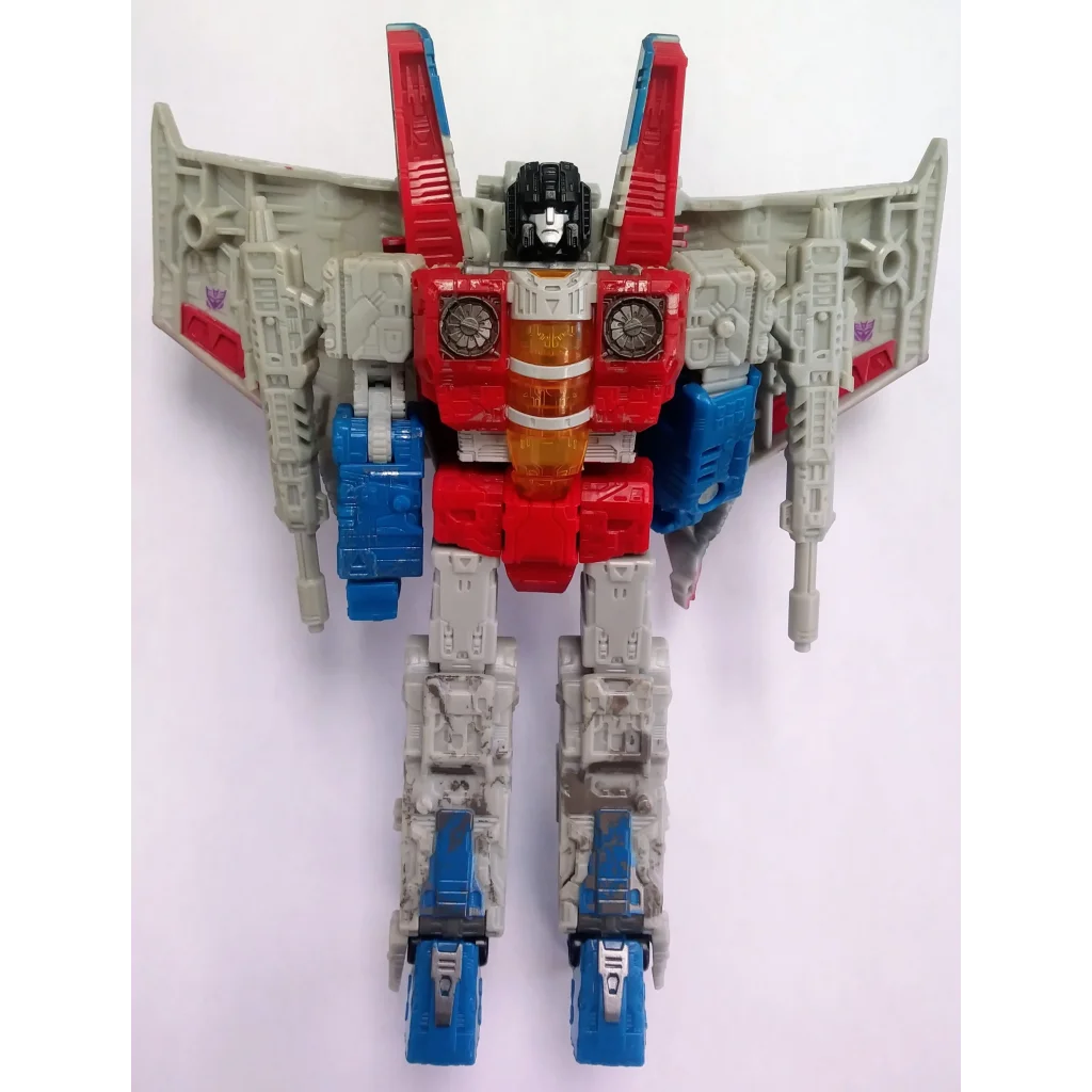 Red white and blue Decepticon Starscream Transformers action figure with wings taking flight
