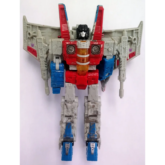 Red white and blue Decepticon Starscream Transformers action figure with wings taking flight