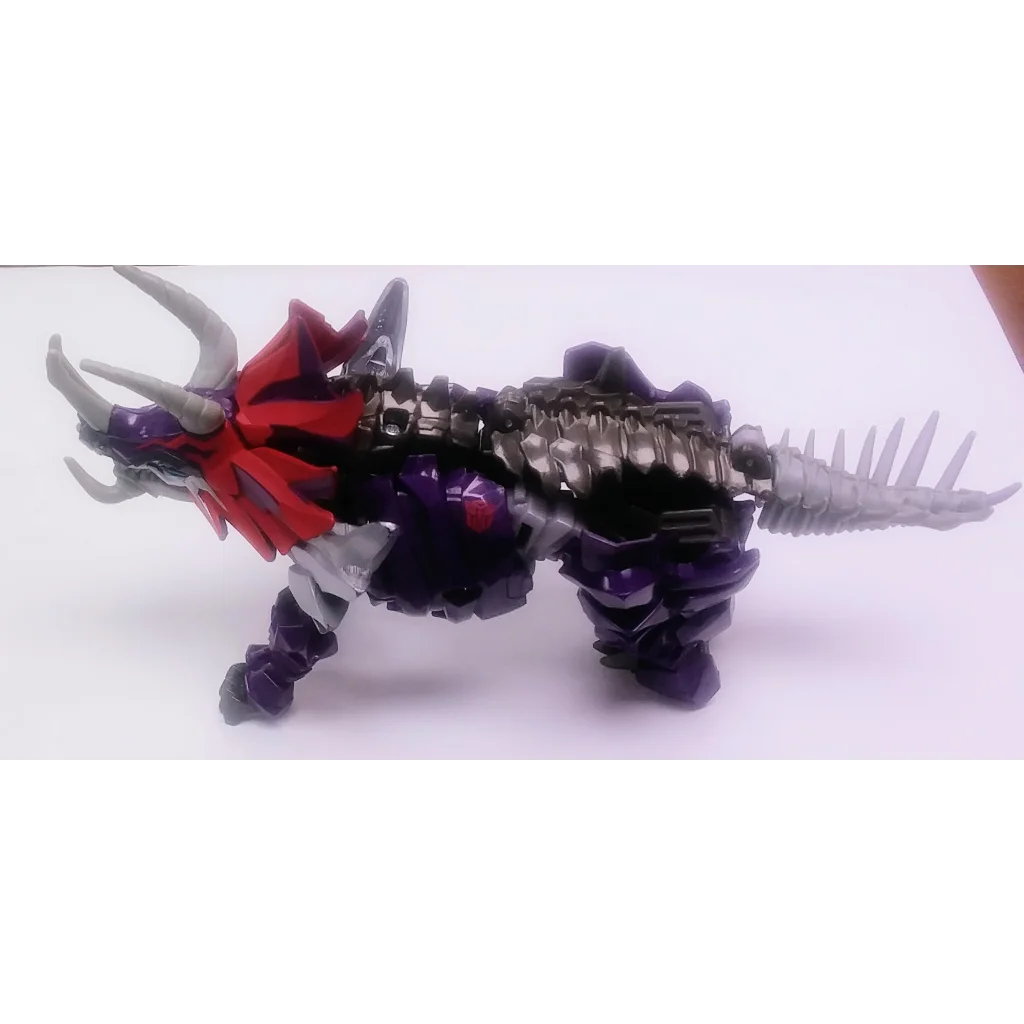 Black and red Dinobot Slug Transformers action figure with purple accents