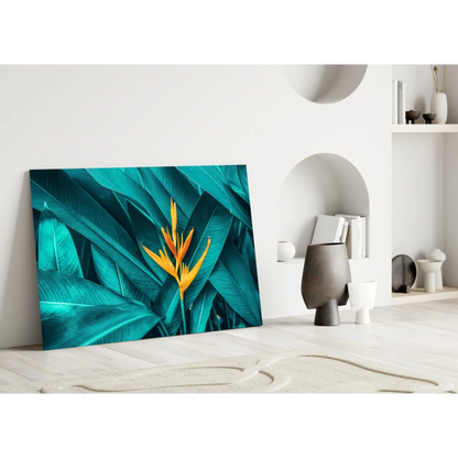 Vibrant teal and yellow bird of paradise glass wall art