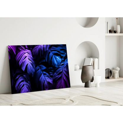 Vibrant purple monstera glass wall art print leaning on white wall