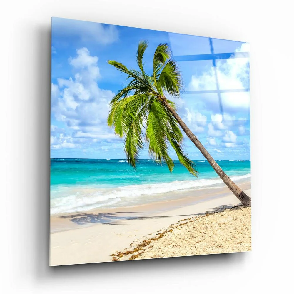Tropical paradise glass wall art with leaning palm tree over turquoise ocean