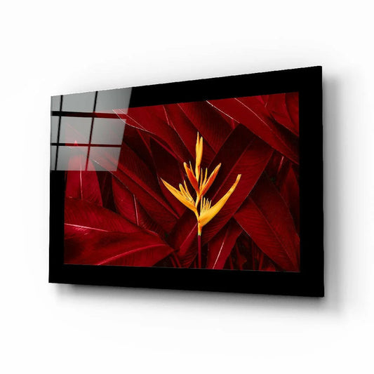 Vibrant yellow bird of paradise in glass wall art with red leaves