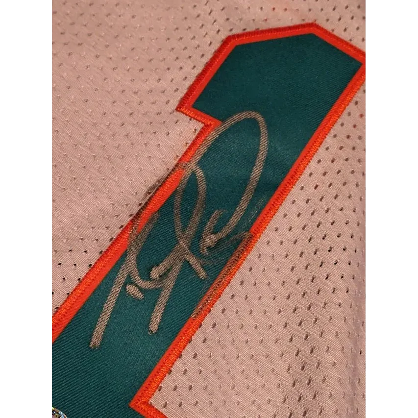 White Tua Tagovailoa Miami Dolphins autographed jersey with teal and orange number 1