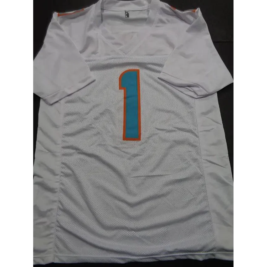 White Tua Tagovailoa Miami Dolphins autographed jersey with teal and orange number 1