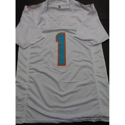 White Tua Tagovailoa Miami Dolphins autographed jersey with teal and orange number 1