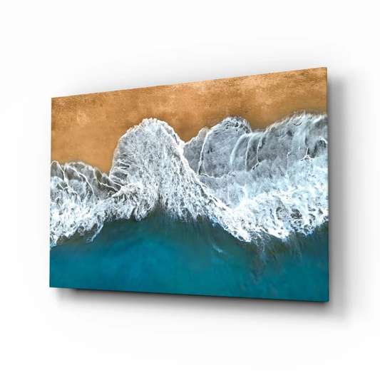 Dynamic turquoise ocean waves crashing on golden sand glass wall art