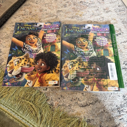 Two Disney Encanto coloring books with vibrant characters and leopard pages