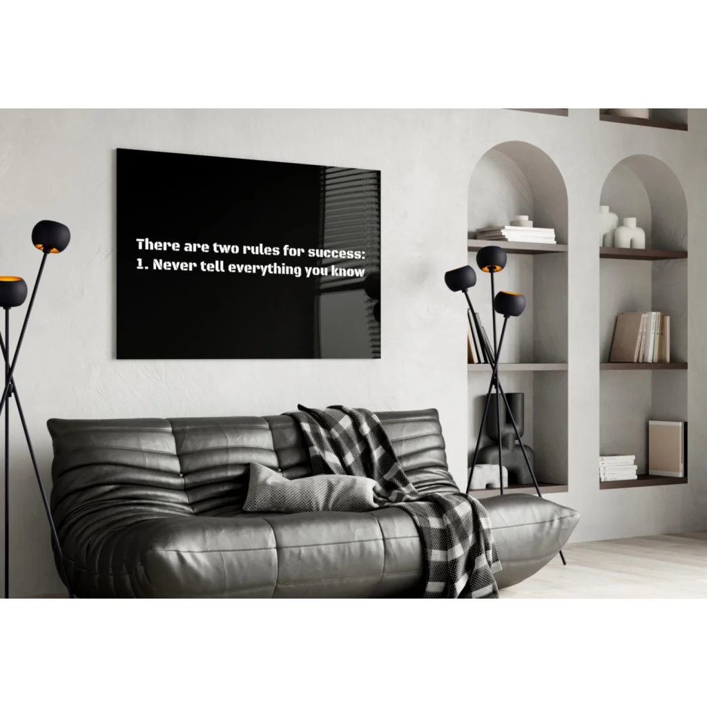 Black rectangular wall art with white text: there are two rules for success: 1