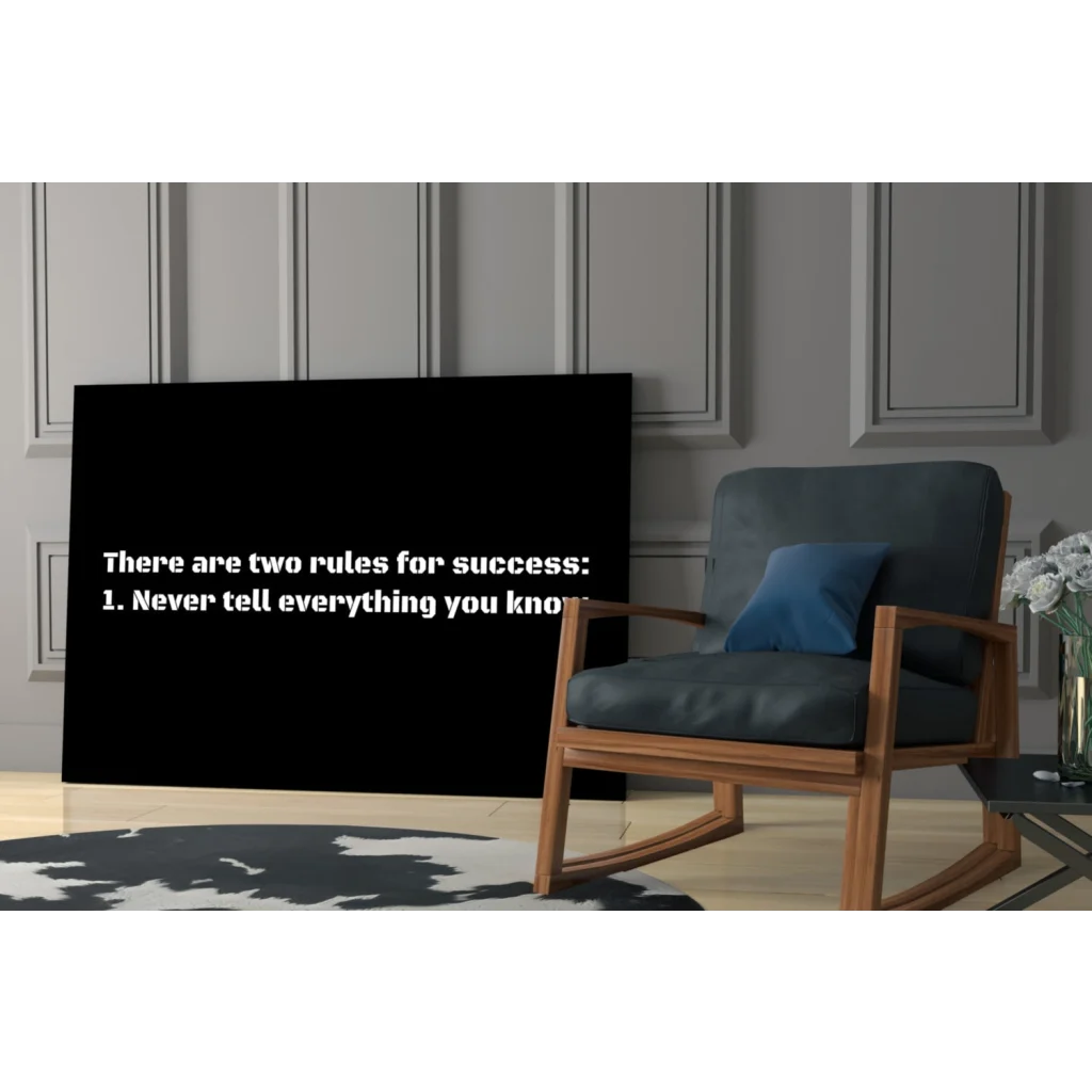 Dark blue rocking chair with wooden frame under Success Rules wall art