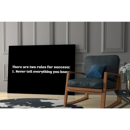 Dark blue rocking chair with wooden frame under Success Rules wall art