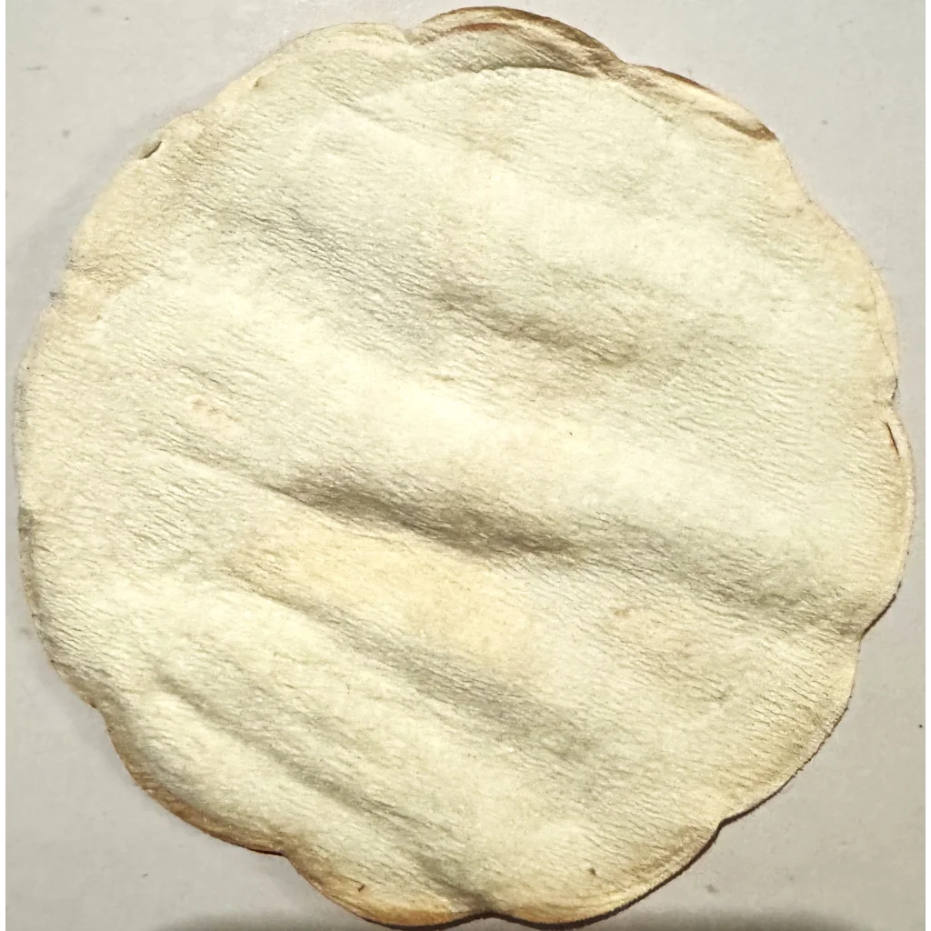 Off-white flatbread with uneven texture on Rare Two Vintage 1950s Herman Jansen Coasters