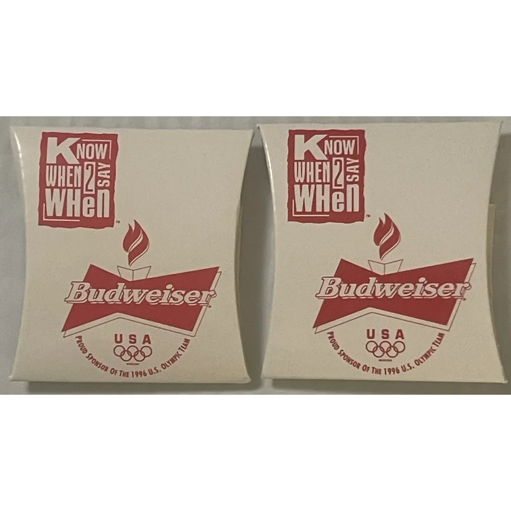 Two white Budweiser coasters with USA Olympic logos in a vintage sewing kit