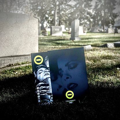 Two black comic books with yellow circular logos and a skull design in the type o negative bloody kisses 30 deluxe bundle