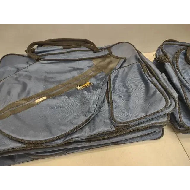 Stack of blue borame tennis racket duffle bags with black trim and handles for athletes