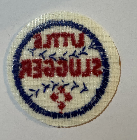Reverse of the Little Slugger patch showing open weave backing and no iron-on adhesive