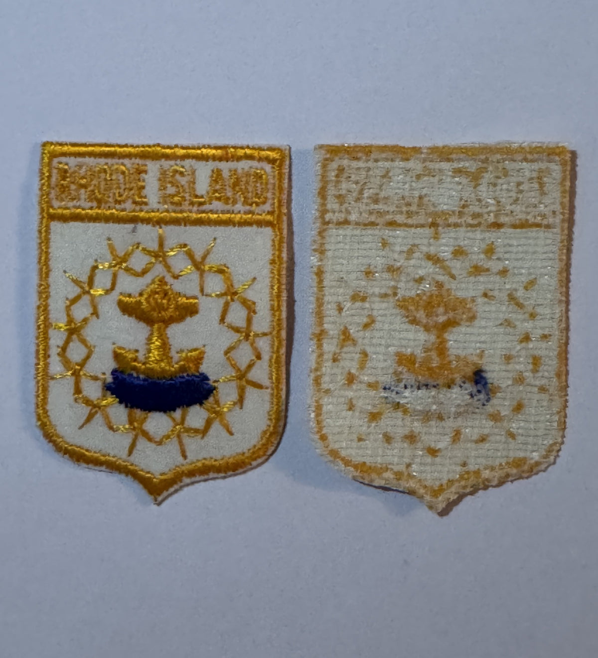 Rhode Island shield patch beside a US quarter, two and a half inches tall