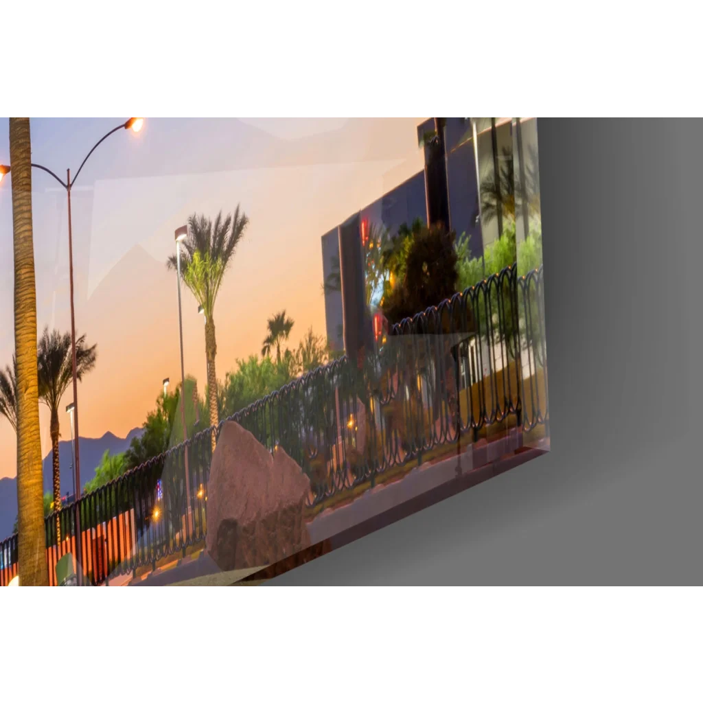 Glossy glass wall art print of sunset with palm trees and buildings