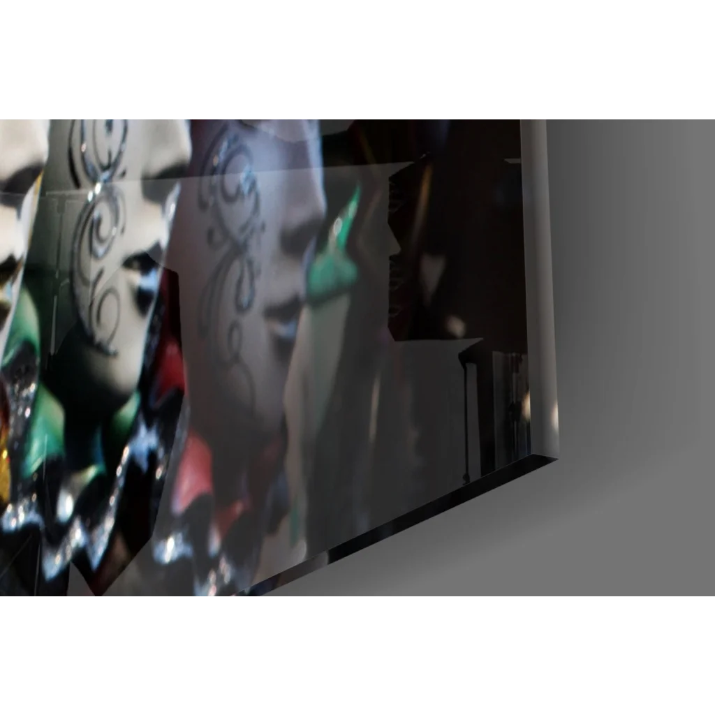 Sleek black-framed glass wall art of Venetian masks with gold, silver, and green accents