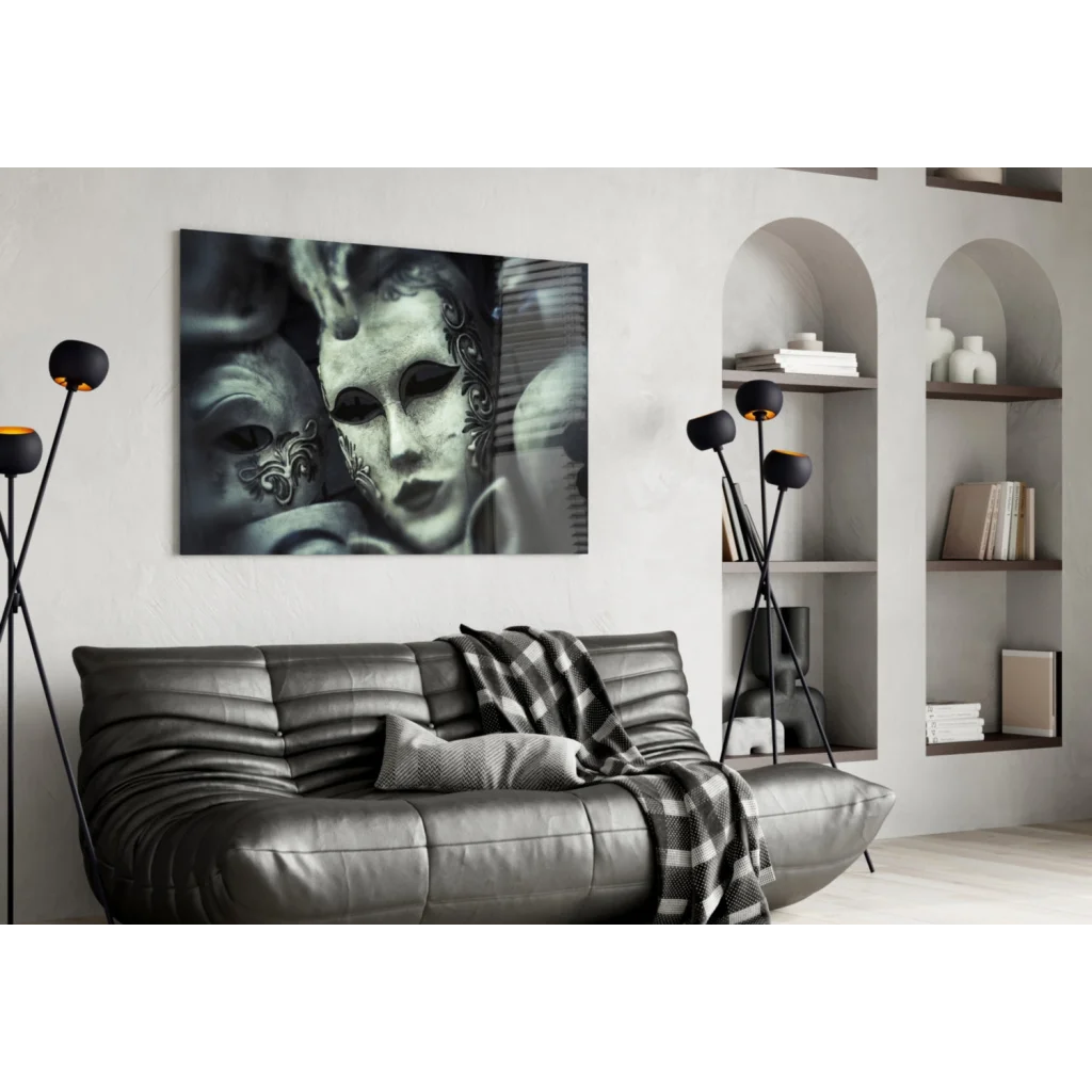 Black leather sofa with tufted cushions and plaid throw, near Venetian Masks wall art