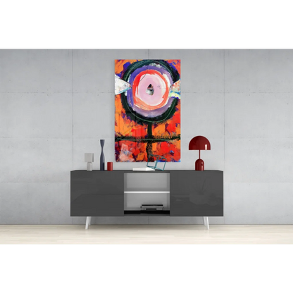Modern gray sideboard with sleek white legs under vibrant orange pink wall art
