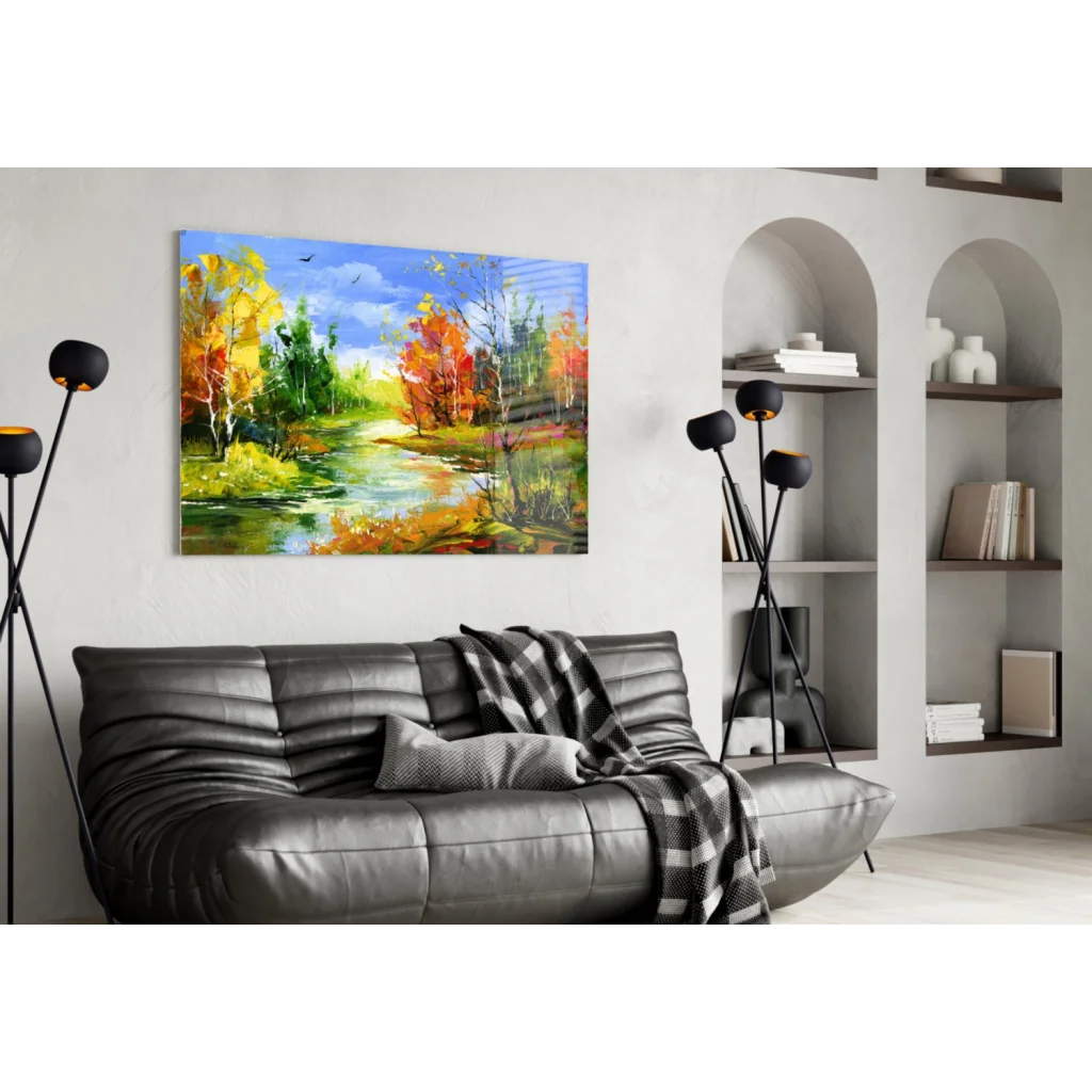 Modern black leather sofa with plaid throw and wooden legs under Vibrant Autumn River wall art