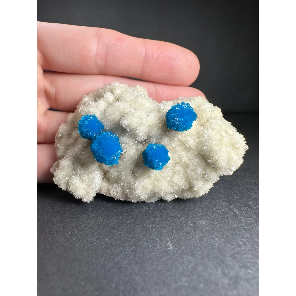 Vibrant blue cavansite balls on white stilbite matrix from India