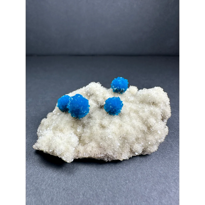Vibrant blue cavansite balls on white stilbite matrix from India