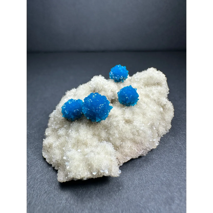 Vibrant blue cavansite balls on white stilbite matrix from India