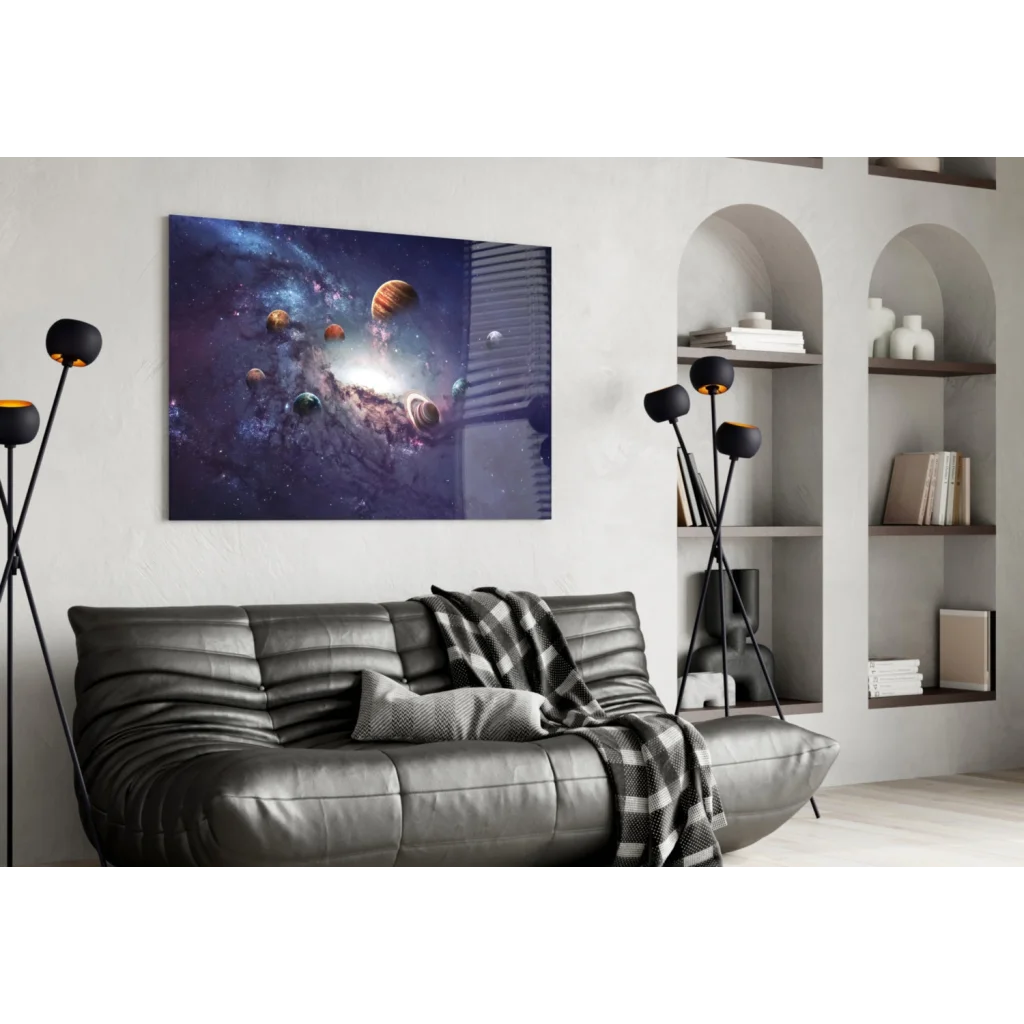 Black leather couch with plaid blanket and cosmic planets wall art