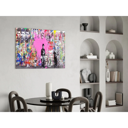 Vibrant pink heart urban wall art with graffiti figures on gray background