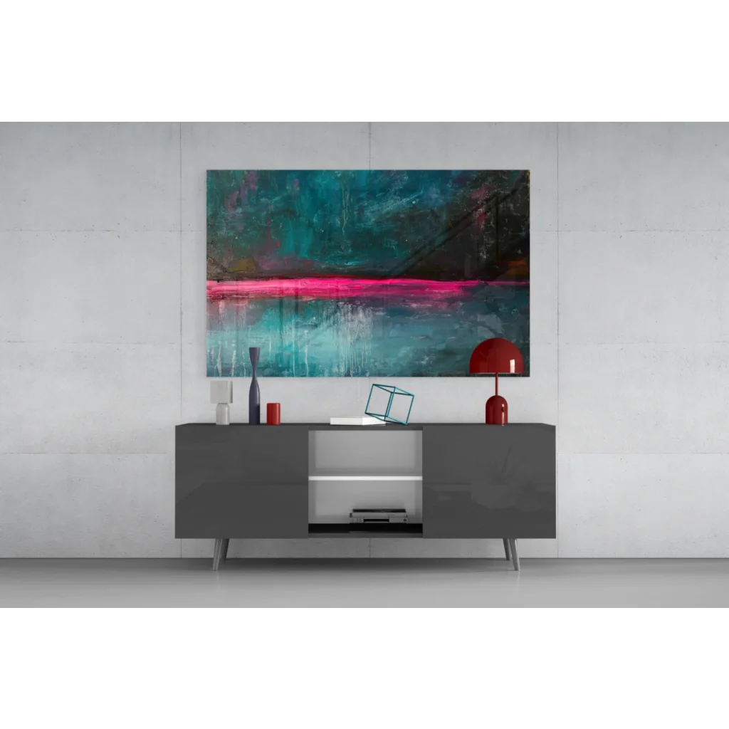 Modern black lacquered sideboard with sleek silver legs under vibrant pink teal abstract wall art