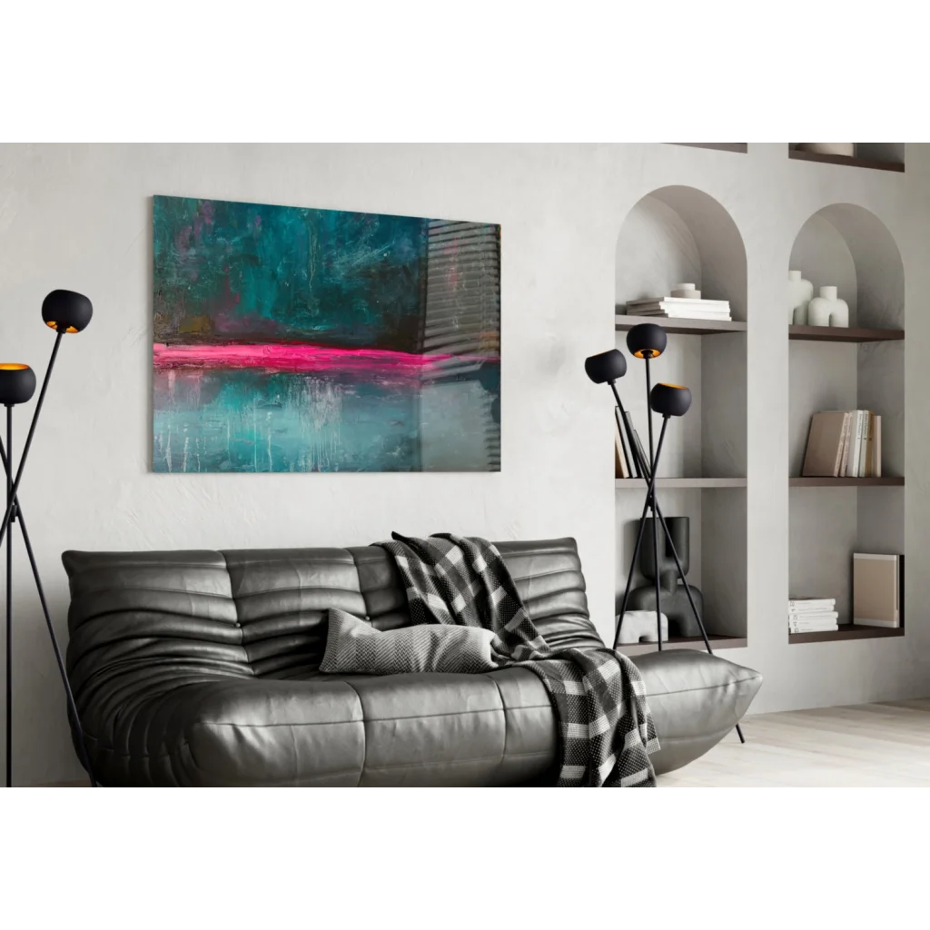 Modern leather sofa with black gray throw under vibrant pink teal wall art