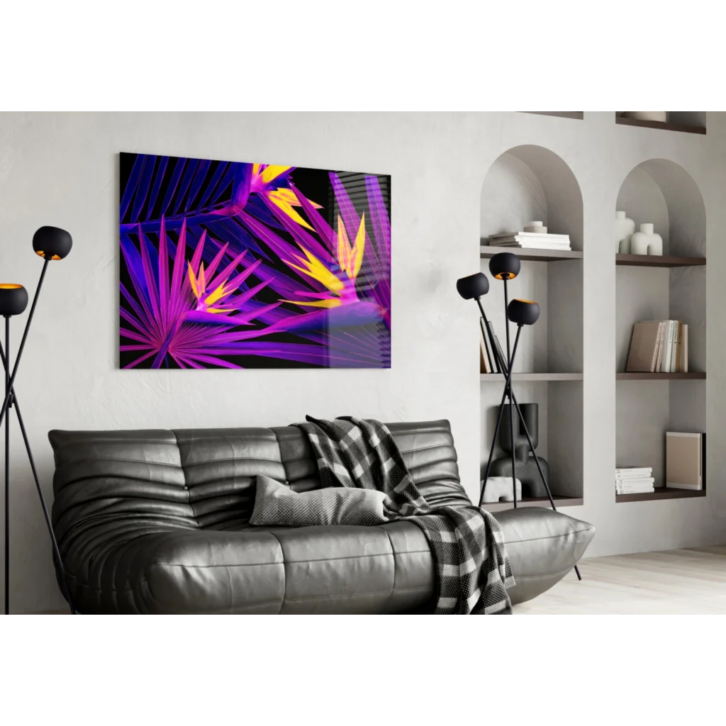 Black leather couch with plaid blanket under vibrant purple tropical leaf wall art