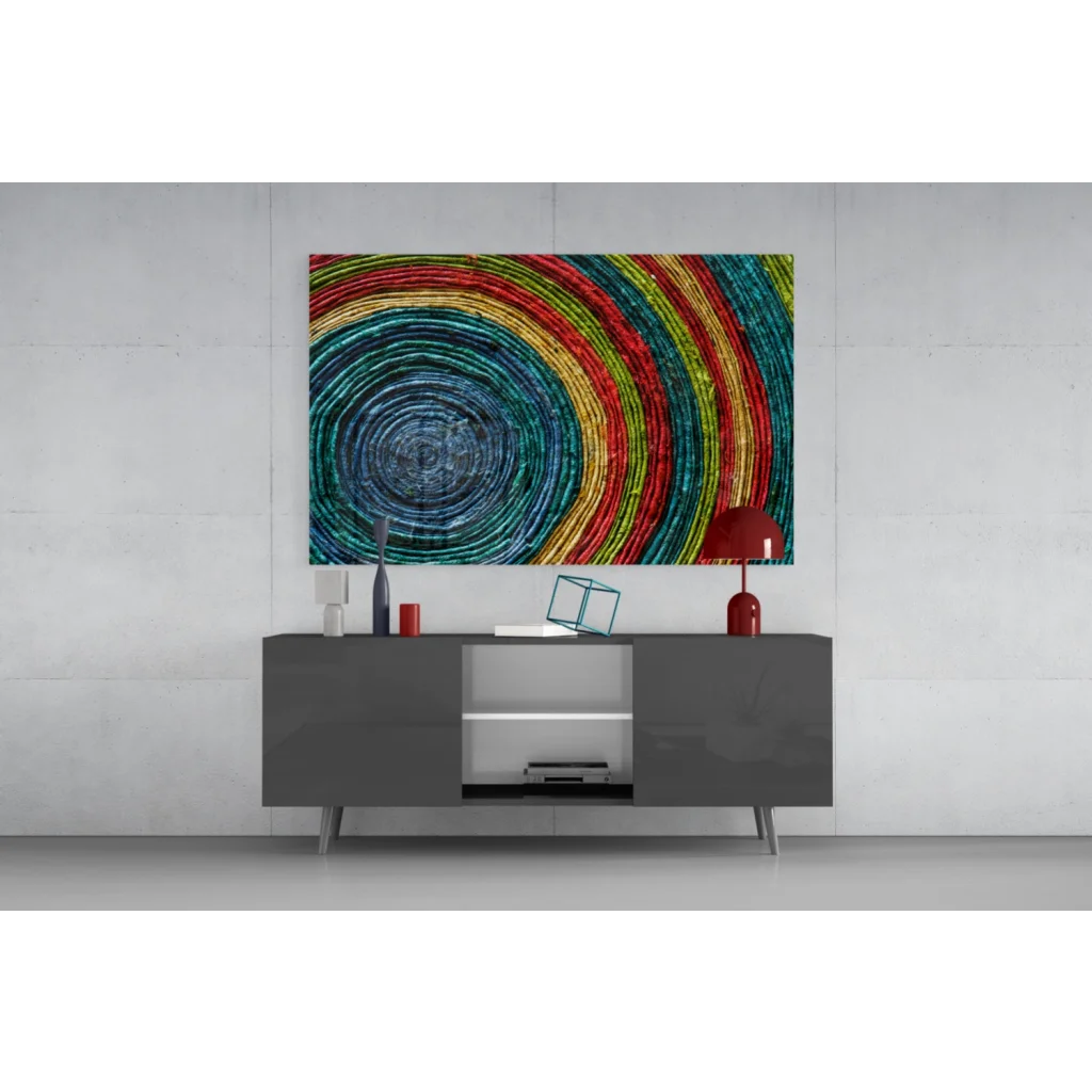 Modern gray sideboard with sleek silver legs under vibrant rainbow spiral wall art