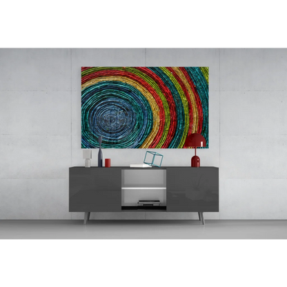 Modern gray sideboard with sleek silver legs under vibrant rainbow spiral wall art