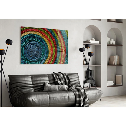 Vibrant rainbow spiral wall art canvas print on leather sofa with plaid throw