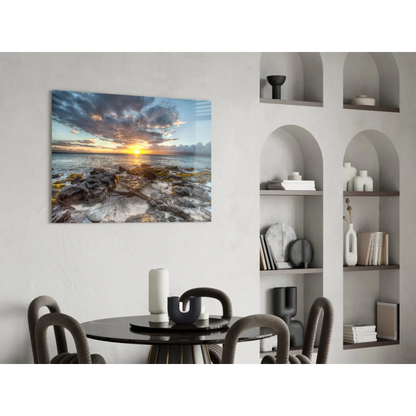 Modern black dining table with curved legs and vibrant sunset rocky shore wall art vase
