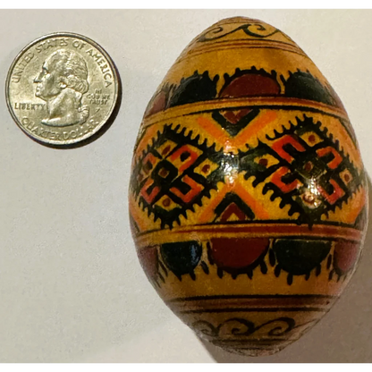 Decorated yellow Ukrainian pysanka egg with traditional charm from Vibrant Ukrainian Pysanka Egg