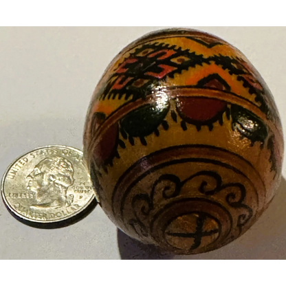 Decorated wooden pysanka egg with vibrant Ukrainian pysanka traditional design