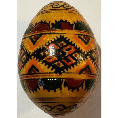 Decorated yellow Ukrainian pysanka egg with traditional vibrant designs for Easter