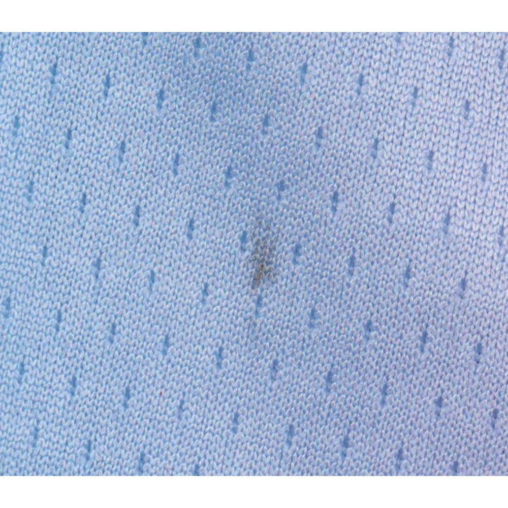 Light blue knitted fabric with dark stain from Victor Oladipo Miami Heat jersey