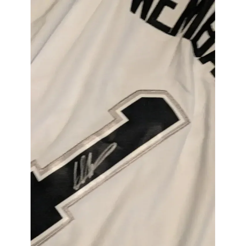White Victor Wembanyama autographed jersey with black and silver number 1 and signature