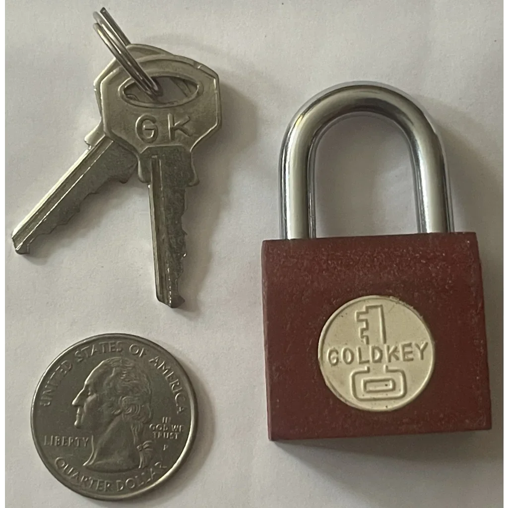 Red padlock with Goldkey logo on Vintage 1950s Goldkey Iron Padlock for gumball machines