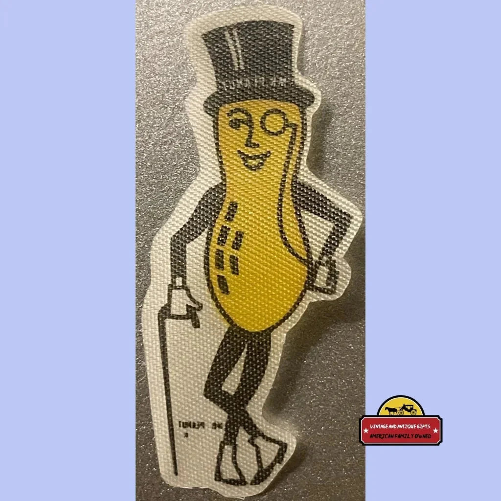 Cartoon Mr. Peanut character in top hat and monocle on a vintage cloth sticker